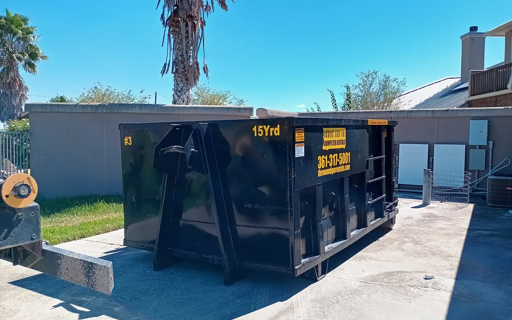 15-yard roll-off dumpster being delivered to a home in Corpus Christi
