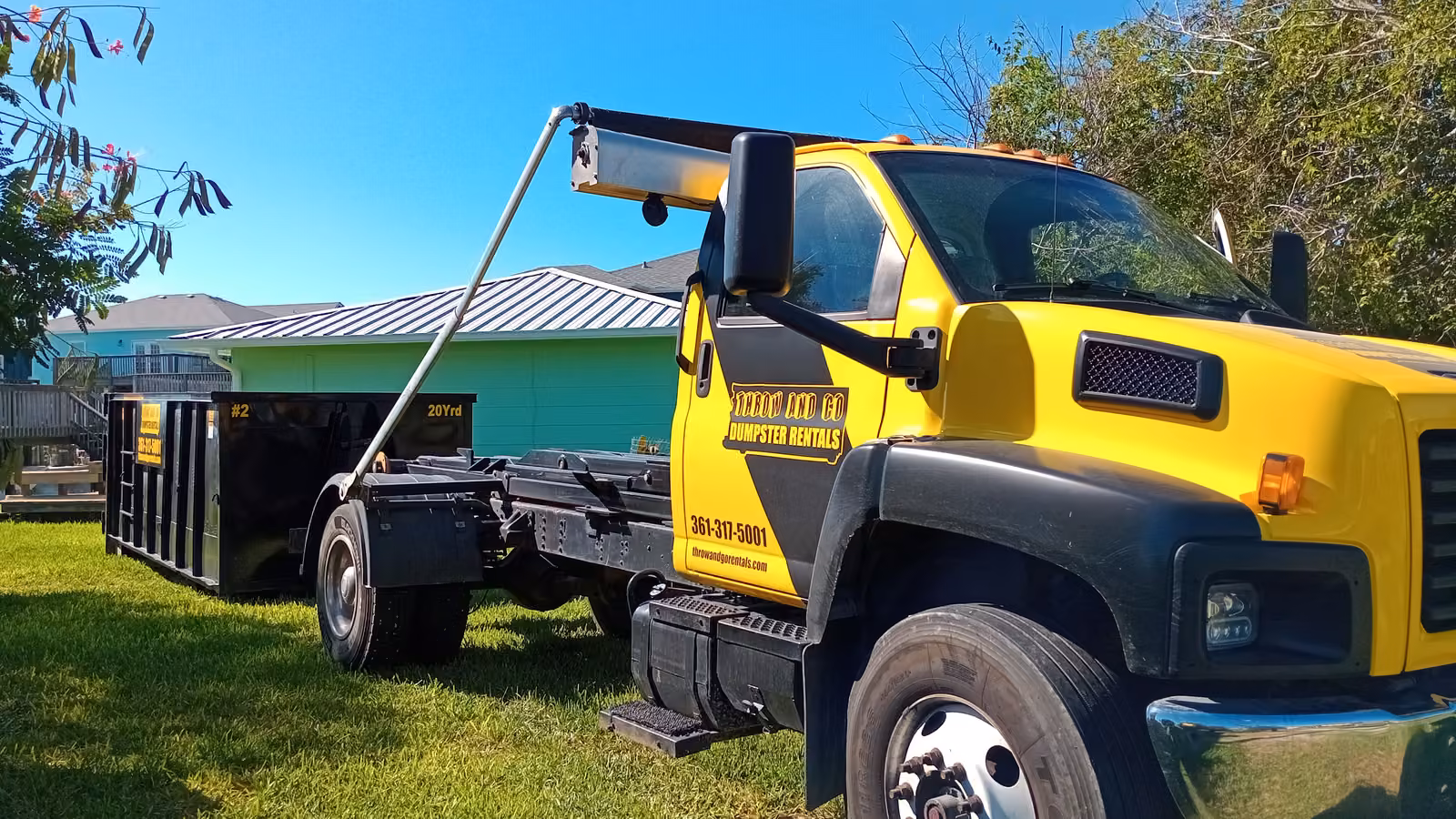 Throw and Go black and yellow roll-off truck in Corpus Christi