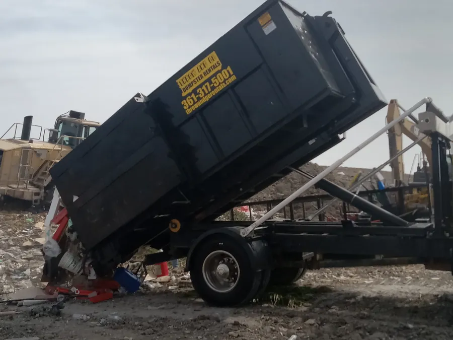 Throw and Go roll-off truck dumping a full load at the landfill near Corpus Christi