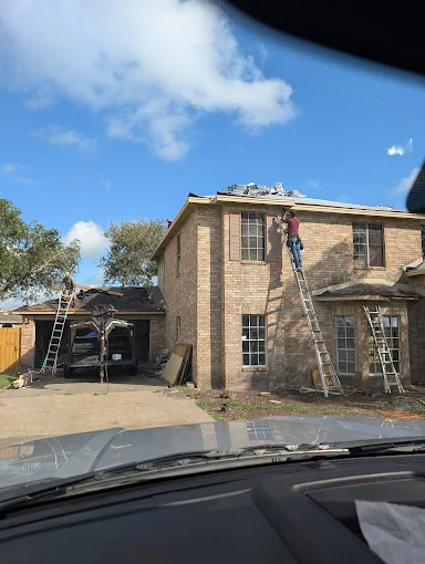 Roll-off dumpster filled with roofing shingle tear-off debris in Corpus Christi